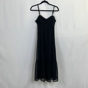 Fitted black spaghetti strap dress and corset and ruffle detail and tiered skirt